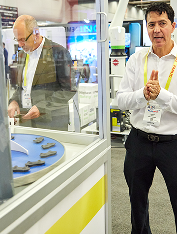 an exhibitor explaining to attendee